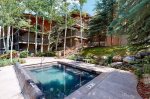 On-site amenities, include a shared outdoor heated pool, a hot tub